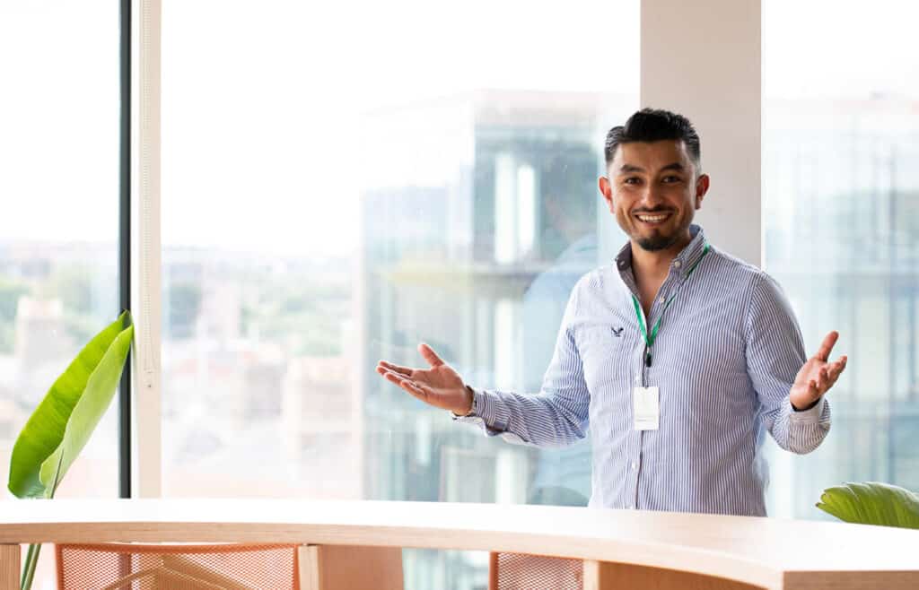 Coworker smiling by a window in the Ireland office | Bentley Systems | Infrastructure Engineering Software Company Coworker smiling by a window in the Ireland office